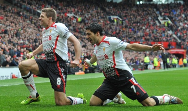 Liverpool's English midfielder Steven Gerrard (L) celebrates with Liverpool's Uruguayan forward Luis Suarez after Gerrard scored his team's second goal during the English Premier League football match between Manchester United and Liverpool at Old Trafford in Manchester, Northwest England, on March 16, 2014. AFP PHOTO/PAUL ELLIS RESTRICTED TO EDITORIAL USE. NO USE WITH UNAUTHORIZED AUDIO, VIDEO, DATA, FIXTURE LISTS, CLUB/LEAGUE LOGOS OR ?LIVE? SERVICES. ONLINE IN-MATCH USE LIMITED TO 45 IMAGES, NO VIDEO EMULATION. NO USE IN BETTING, GAMES OR SINGLE CLUB/LEAGUE/PLAYER PUBLICATIONS.