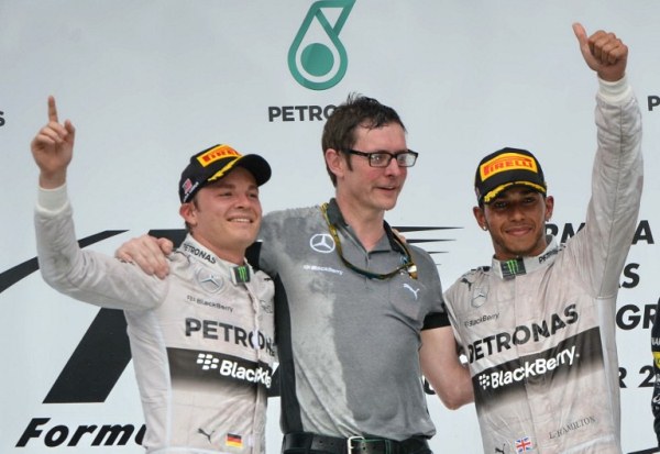 WE DID IT: Mercedes drivers Lewis Hamilton (right) and Nico Rosberg (left) celebrate with Andy Shovlin, chief driver engineer for Mercedes, on the podium after the Formula One Malaysian Grand Prix. AFPpic