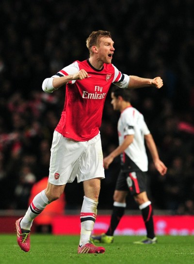 Arsenal's German defender Per Mertesacker celebrates on the final whistle of the English FA Cup fifth round football match between Arsenal and Liverpool at The Emirates Stadium in north London on February 16, 2014. Arsenal won the game 2-1. AFP PHOTO / GLYN KIRKRESTRICTED TO EDITORIAL USE. No use with unauthorized audio, video, data, fixture lists, club/league logos or ?live? services. Online in-match use limited to 45 images, no video emulation. No use in betting, games or single club/league/player publications.