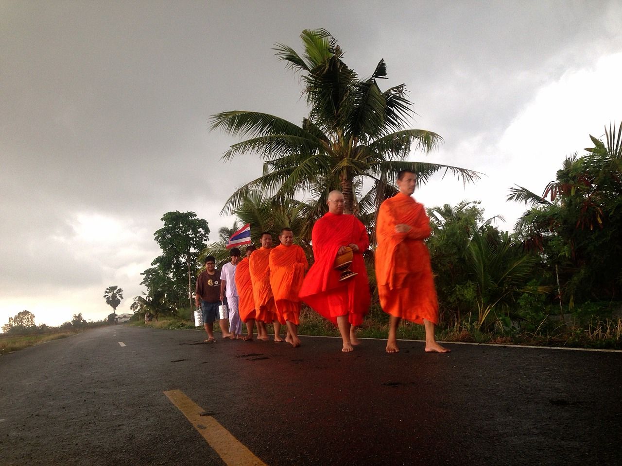 Kiradech Aphibarnrat with other monks on their daily walk to gather food. Photo credit: Jitti Sritanapol & Lewan-DowSki