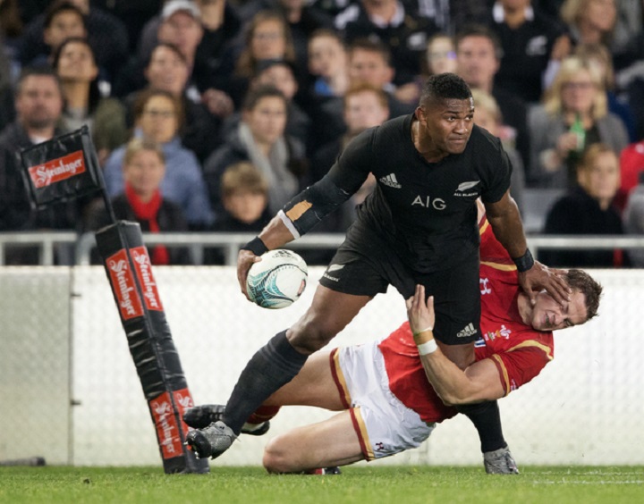 New Zealand All Black Waisake Naholo, left, fends off a Welsh defender during their rugby union test match in Auckland, New Zealand, Saturday, June 11, 2016. (Greg Bowker/New Zealand Herald via AP) NEW ZEALAND OUT, AUSTRALIA OUT