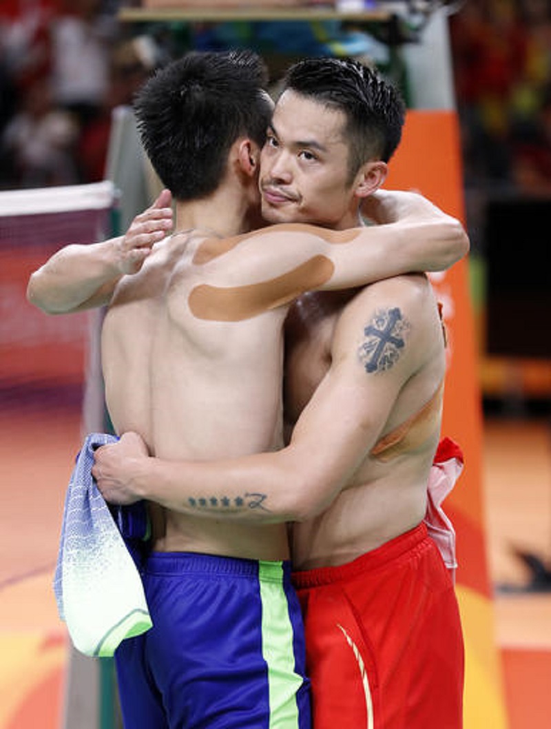 Malaysia's Lee Chong Wei, left, hugs China's Lin Dan, right, as they trade shirts after Lee won their men's badminton singles semifinal match at the 2016 Summer Olympics in Rio de Janeiro, Brazil, Friday, Aug. 19, 2016. (AP Photo/Vincent Thian)